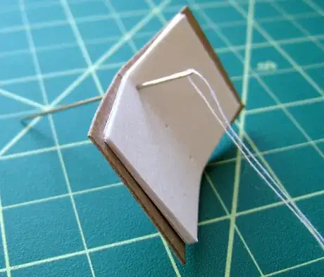 Image intitulée Stitch down through the top hole.