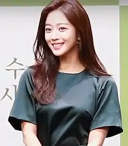 Jo in green dress and smiling for the camera