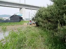 Tractor passing under the KTX line in Yacheon-ri, Hwaseong.mw-parser-output .geo-default,.mw-parser-output .geo-dms,.mw-parser-output .geo-dec{display:inline}.mw-parser-output .geo-nondefault,.mw-parser-output .geo-multi-punct{display:none}.mw-parser-output .longitude,.mw-parser-output .latitude{white-space:nowrap}37°14′49″N 126°55′17″E﻿ / ﻿37.24694°N 126.92139°E﻿ / 37.24694; 126.92139