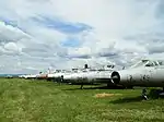 Outdoor exposition of aircraft, various Mig-21 fighters