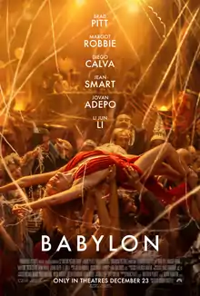 A blonde woman in a red dress (Nellie LaRoy, played by Margot Robbie) crowdsurfs at a party.