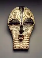 Female kifwebe mask; late 19th or early 20th century; 30.5 x 18.1 x 15.6 cm (12 x 7.mw-parser-output .frac{white-space:nowrap}.mw-parser-output .frac .num,.mw-parser-output .frac .den{font-size:80%;line-height:0;vertical-align:super}.mw-parser-output .frac .den{vertical-align:sub}.mw-parser-output .sr-only{border:0;clip:rect(0,0,0,0);clip-path:polygon(0px 0px,0px 0px,0px 0px);height:1px;margin:-1px;overflow:hidden;padding:0;position:absolute;width:1px}1⁄8 x 6.mw-parser-output .frac{white-space:nowrap}.mw-parser-output .frac .num,.mw-parser-output .frac .den{font-size:80%;line-height:0;vertical-align:super}.mw-parser-output .frac .den{vertical-align:sub}.mw-parser-output .sr-only{border:0;clip:rect(0,0,0,0);clip-path:polygon(0px 0px,0px 0px,0px 0px);height:1px;margin:-1px;overflow:hidden;padding:0;position:absolute;width:1px}1⁄8 in.); Brooklyn Museum. The kifwebe masquerade is a genre shared by the Luba and Songye, indicative of the interaction that has occurred between the two societies. Kifwebe masks represent either male or female beings