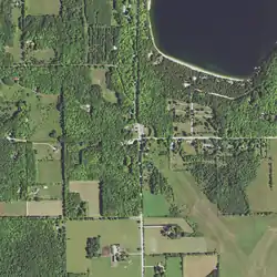 Main Road (center) runs north–south and forms a T intersection with Jackson Harbor Road running east. County Trunk Highway W (CTH-W) coincides with Little Lake Road (top left), which runs east–west. Little Lake Road turns south and ends with a junction at Main Road. At the southeast terminus of Little Lake Road, CTH-W continues, following south along Main Road. Washington Harbor is at the top right.