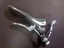 Cusco's self retaining bivalve vaginal speculum (closed) seen from the left. It  is very much used in taking smears from the vagina for Papanicolaou test and routine examinations.