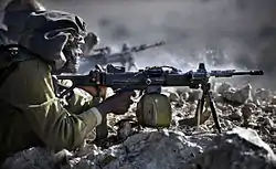 IDF infantry soldier fires a Negev NG-5 light machine gun during training