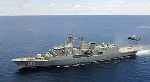 HMAS Ballarat with a US Navy helicopter in 2012