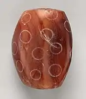 Indus Civilisation Carnelian bead with white design, c. 2900–2350 BC. Found in Nippur, Mesopotamian.
