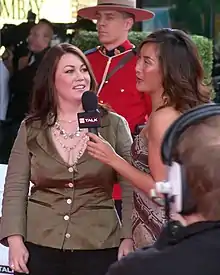 Arden (left), being interviewed on television, 2006