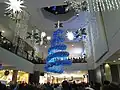 A Christmas Tree light show being held in the mall's centre court on November 14, 2009. Cookies by George, Cinnzeo, and the former Second Cup can be seen.