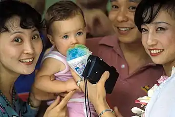 Members of the Chinese People's Liberation Army Air Force Song and Dance Troupe enjoying Hawaiian shave ice (c. 1986)