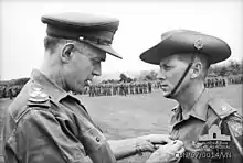 B/W Photo of Brigadier (Oliver) David Jackson pinning the Military Cross on Harry Smith in military uniform, 1967
