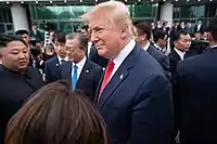 The three leaders talking together in front of the Freedom House on 2019 Koreas–United States DMZ Summit