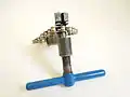 Relieving tension between outer plates of a bicycle chain with a chain tool