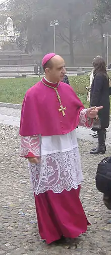 His Excellency Monsignor Rino Fisichella wearing a rochet with lace.