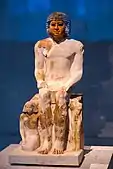 Seated portrait statue of a man with his two sons; circa 2400 BC; painted limestone; from Saqqara; Egyptian Museum of Berlin