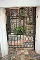 Gate with colorful paving elements