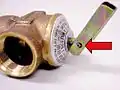 Coiled spring pin secures the lift lever relative to the valve rod