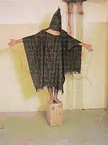 A prisoner called Abdou Hussain Saad Faleh being psychologically tortured at Abu Ghraib. He was told if he moved, or fell off the block, he would be electrocuted. The picture became internationally recognised.