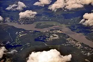 Aerial view of West Point, 2013. West Point is at center on the near (western) side of the Hudson river. Highland Falls is at right; Cold Spring is at left, across the river in Putnam County.