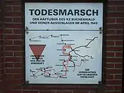 A red triangle on a historical marker. The marker shows the route prisoners were forced to take on the Buchenwald death march (Todesmarsch).