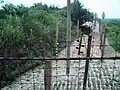 Crossing into the DPRK's part of Joint Security Area within the DMZ. The fence is electrified and the strip is mined.