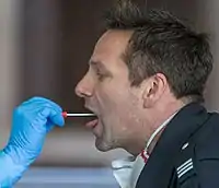 Demonstration of a throat swab for COVID‑19 testing