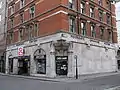 The western side of the main building has one of two entrances on Moorfields, with Moorgate visible on the extreme right in the background