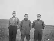Albertan farmers wore masks to protect themselves from the flu.
