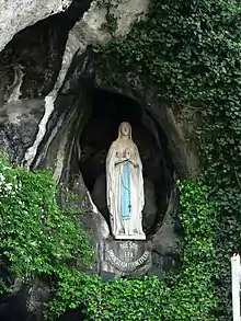 A statue of the Virgin Mary stands at the sacred site of Lourdes in France.