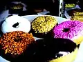 Frosting and colored sprinkles on doughnuts