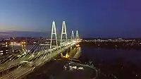 Meeting of the auto club under the Cable-stayed bridge in the evening