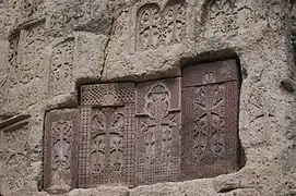 Khachkars (cross-stones) at Geghard Monastery painted with vordan karmir