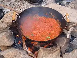 Qalayet Bandora cooked over a campfire in Wadi Mukheiris, near the Jordanian coast of the Dead Sea.