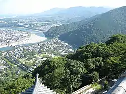 View of Iwakuni City, Yamaguchi Prefecture from Iwakuni Castle. The famous Kintai Five Bow Bridge can be seen over the Nishiki River.