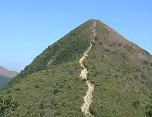 Steep mountain with clear dirt path leading to summit