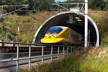 A high-speed passenger train with Jake painted on the nose and side