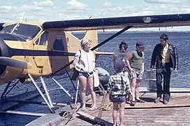 Pilot and passengers, returning from an excursion, Air Saguenay, Havre-Saint-Pierre seaplane base, Lac des Plaines, known as Lac d'avion