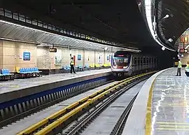 Top: Outside view of Imam Khomeini stationBottom: A train at the Ghoddoosi Metro Station