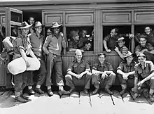 Soldiers milling around a stationary train, ready to entrain