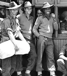 Soldiers leaning against a stationary train