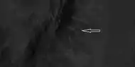 Close view of ridges from previous HiRISE image  Arrow indicates an X-shaped ridge.