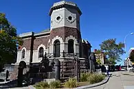 135th St Croton Aqueduct Gatehouse in New York City has a brick two story octagonal tower with stone work at its base