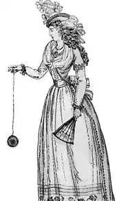 A 1791 illustration of a woman playing with an early version of the yo-yo, then known as a "bandalore"