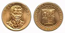 A gold medallion depicting the bust of a man, as well as a painting