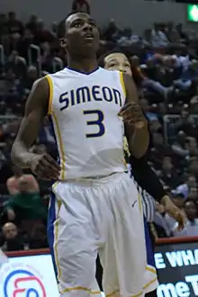 Ingram standing on a basketball court looking up.