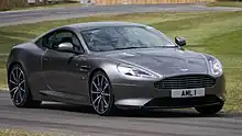 A dark grey DB9 GT on a racing track