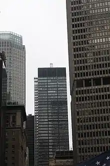 The facade of 270 Park Avenue as seen from the south in 2019. There are other buildings on either side of the structure.