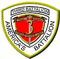 A white shield with a red interior and a gold border. On the top is written "Third Battalion" and on the bottom written "America's Battalion". The red interior has a "3" in the center with a sword running through it with the words "Third Marines" on the top and "Fortes Fortuna Juvat" on the bottom.