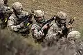 Royal Marines wearing a combination of MultiCam (uniform, helmet cover) and MTP (body armour, load carrying equipment) items at Bovington Training Area, 2021