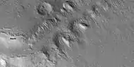 Close view of slopes that contain tilted layered features, as seen by HiRISE under HiWish program.  Note: this is an enlargement from the previous image.